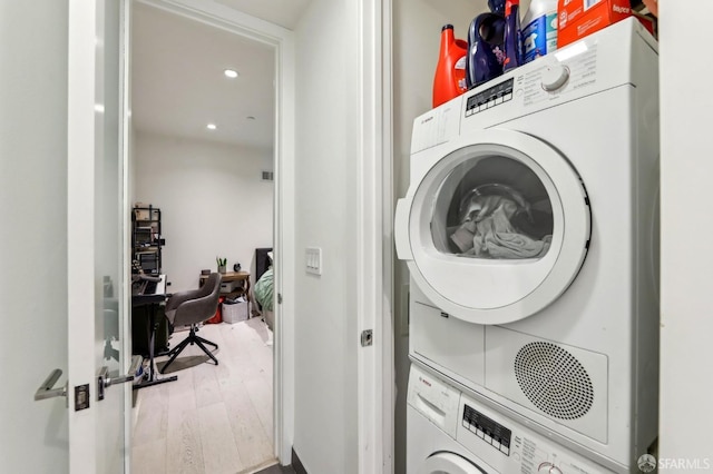1875 Mission St Unit 304, San Francisco, CA 94103 - washroom featuring stacked washer / drying machine, wood finished floors, recessed lighting, and a desk