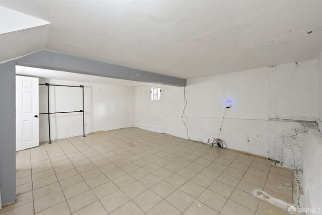 finished basement with light tile patterned flooring