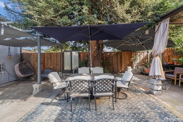 view of patio featuring outdoor dining space and a fenced backyard