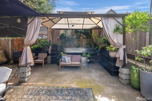 view of patio / terrace with fence, a gazebo, and outdoor lounge area