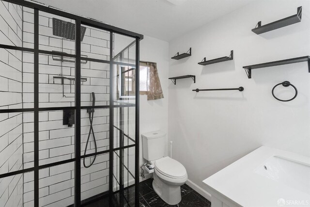 bathroom with toilet, baseboards, marble finish floor, and tiled shower