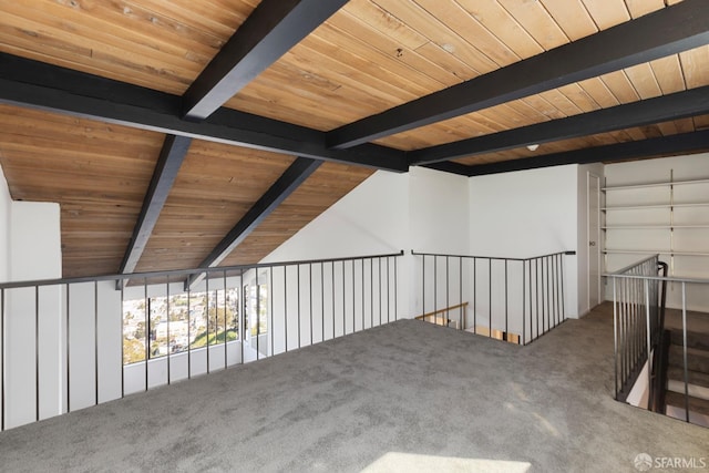 corridor with carpet floors, wooden ceiling, and lofted ceiling with beams