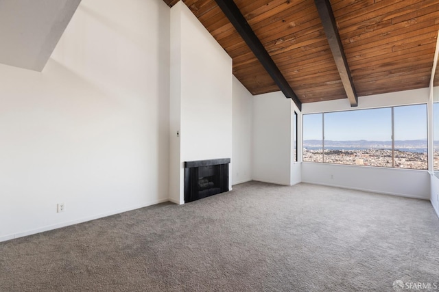 unfurnished living room featuring high vaulted ceiling, carpet floors, a fireplace, wood ceiling, and beamed ceiling