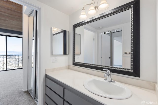 bathroom featuring an inviting chandelier and vanity