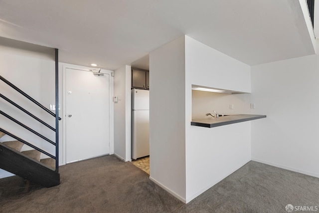 interior space with carpet, stairway, and baseboards