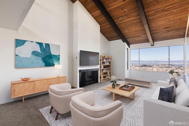 carpeted living room featuring beam ceiling, a fireplace, high vaulted ceiling, wooden ceiling, and baseboards