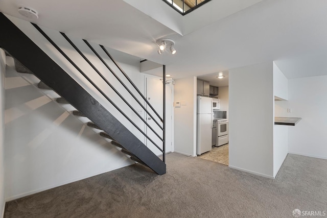 stairway with carpet floors and baseboards