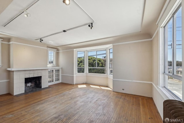 2440-2442 Balboa St, San Francisco, CA 94121 - unfurnished living room with rail lighting, radiator heating unit, wood-type flooring, and a tiled fireplace