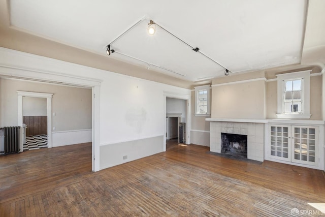2440-2442 Balboa St, San Francisco, CA 94121 - unfurnished living room with radiator, a tile fireplace, wood finished floors, and rail lighting