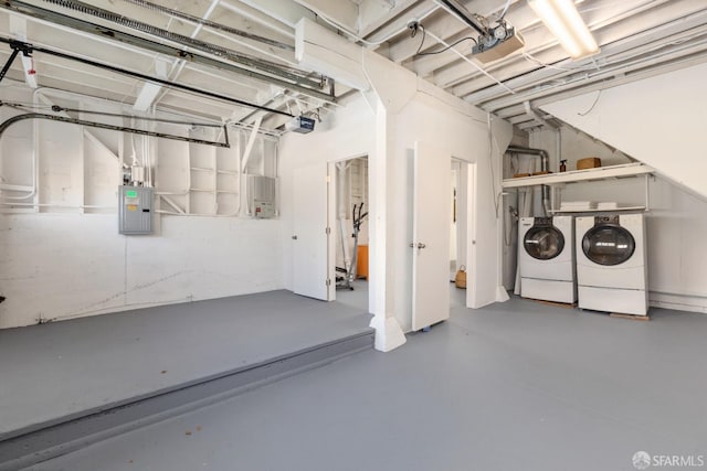 basement featuring washing machine and dryer and electric panel