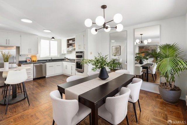 dining area featuring sink and a chandelier