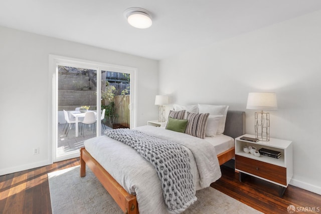 bedroom featuring access to exterior and dark hardwood / wood-style flooring