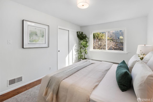 bedroom featuring hardwood / wood-style flooring and a closet