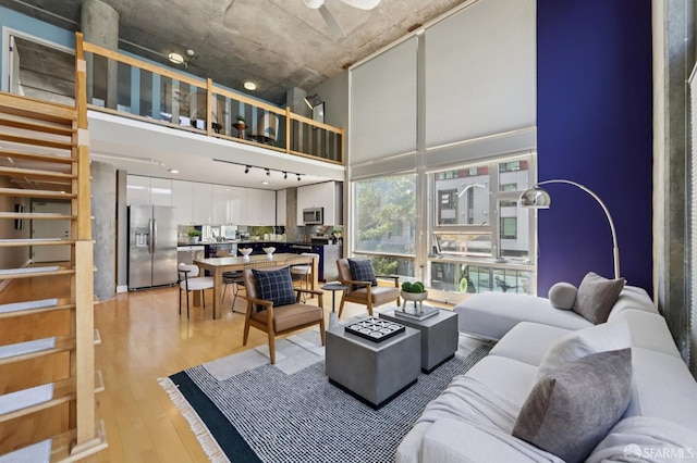 311 Oak St Unit 301, Oakland, CA 94607 - living area with light wood finished floors, a high ceiling, ceiling fan, and track lighting