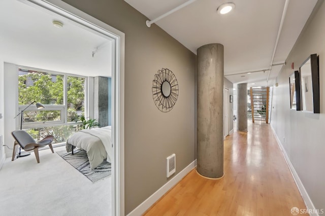 311 Oak St Unit 301, Oakland, CA 94607 - corridor featuring baseboards, decorative columns, and light wood-style floors