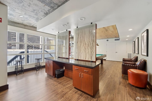 311 Oak St Unit 301, Oakland, CA 94607 - kitchen featuring wood finished floors, open floor plan, dark countertops, billiards, and brown cabinets