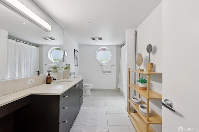 311 Oak St Unit 301, Oakland, CA 94607 - bathroom featuring vanity, toilet, plenty of natural light, and tile patterned floors