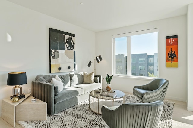 living room with a wealth of natural light and light hardwood / wood-style flooring