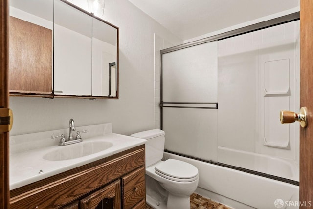 full bathroom featuring vanity, enclosed tub / shower combo, and toilet