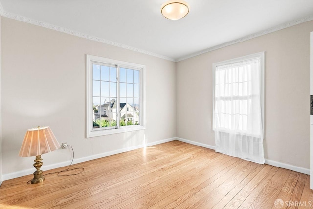 unfurnished room featuring light hardwood / wood-style floors and crown molding