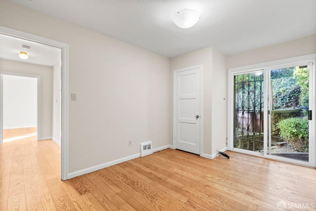 unfurnished room with light wood-type flooring