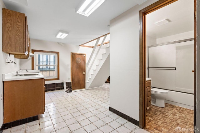 full bathroom featuring tile patterned flooring, vanity, toilet, and shower / bath combination with glass door