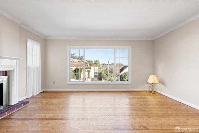 unfurnished living room with light hardwood / wood-style flooring, a brick fireplace, and ornamental molding