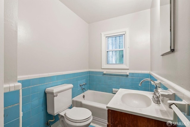 bathroom featuring a washtub, toilet, tile walls, and vanity