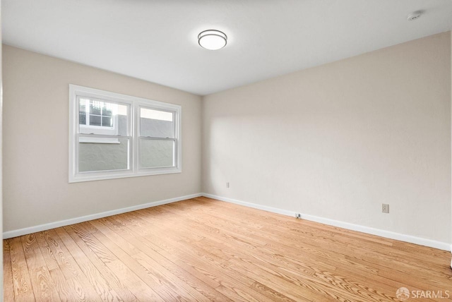 unfurnished room with light wood-type flooring