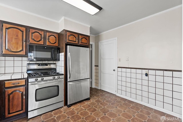 kitchen with dark brown cabinetry, crown molding, and appliances with stainless steel finishes