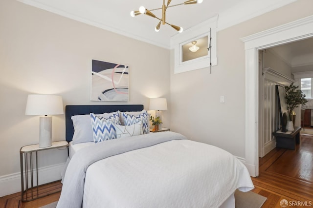 bedroom with dark wood-style floors, baseboards, a chandelier, and crown molding