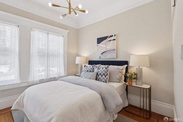 bedroom with baseboards, a chandelier, and crown molding