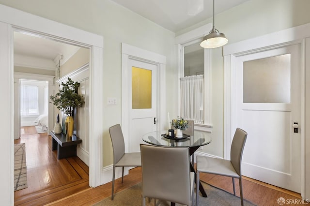 dining room with baseboards and wood finished floors