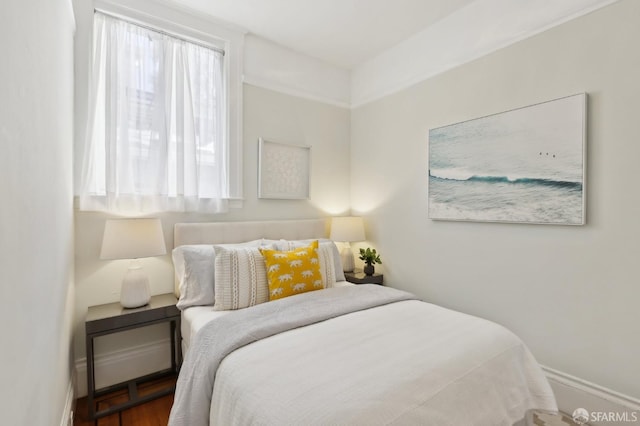 bedroom featuring multiple windows and baseboards