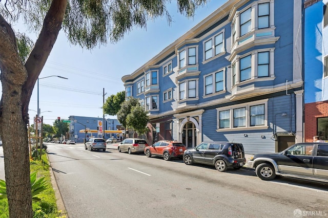 exterior space featuring curbs and street lights