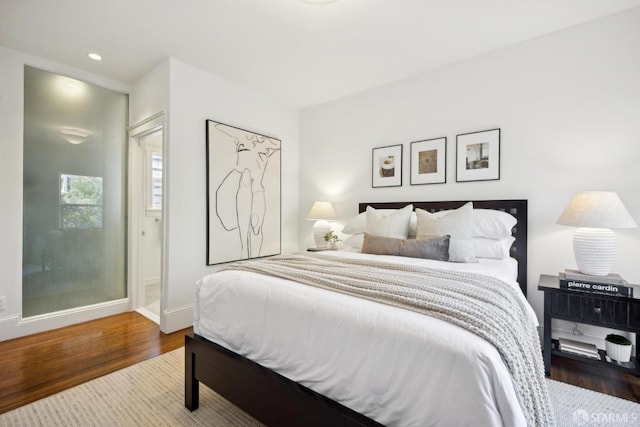 bedroom with recessed lighting, baseboards, and wood finished floors