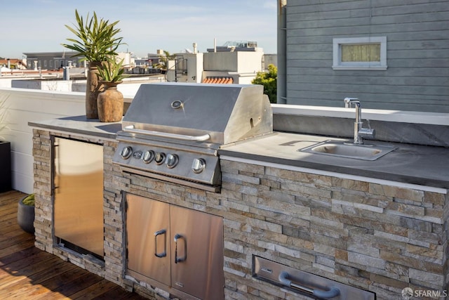 view of patio / terrace featuring an outdoor kitchen, grilling area, and a sink