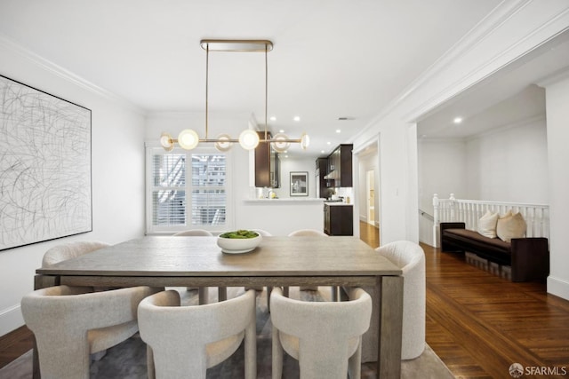 dining room featuring wood finished floors and crown molding