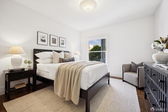 bedroom featuring baseboards and wood finished floors