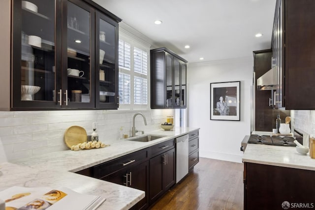 kitchen featuring appliances with stainless steel finishes, a sink, dark wood-style floors, and light stone countertops