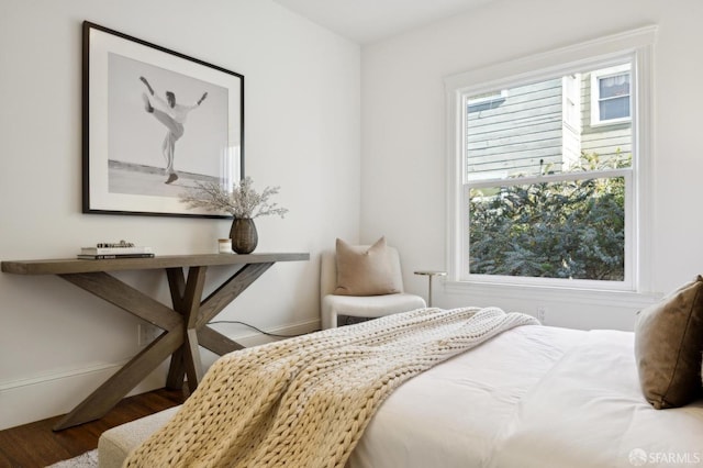 bedroom featuring wood finished floors and baseboards