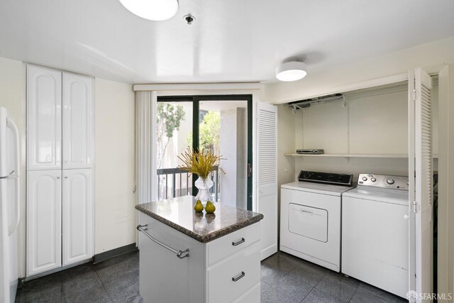 601 Van Ness Ave Unit 39, San Francisco, CA 94102 - laundry area with independent washer and dryer, laundry area, granite finish floor, and baseboards