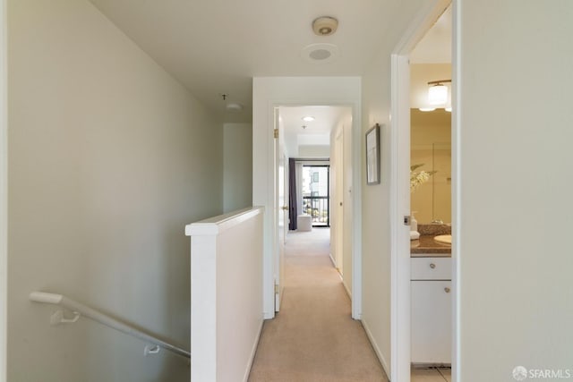 601 Van Ness Ave Unit 39, San Francisco, CA 94102 - hallway with baseboards, light colored carpet, and an upstairs landing