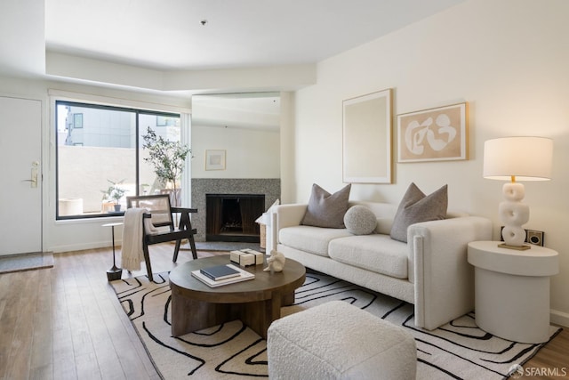 601 Van Ness Ave Unit 39, San Francisco, CA 94102 - living room featuring a fireplace with raised hearth and wood finished floors