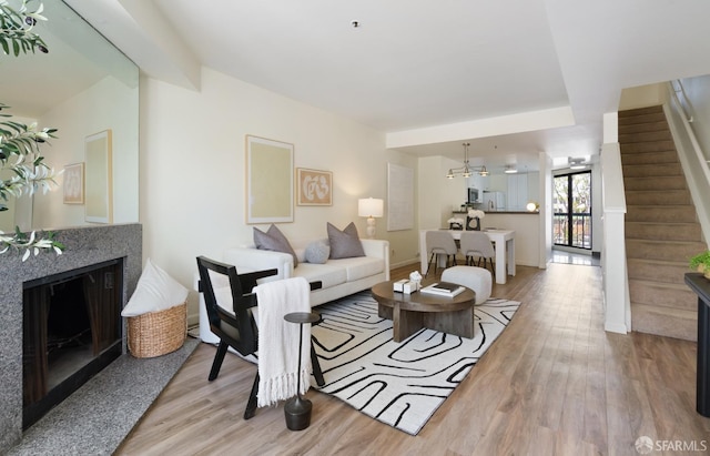 601 Van Ness Ave Unit 39, San Francisco, CA 94102 - living room featuring baseboards, a fireplace, wood finished floors, and stairway