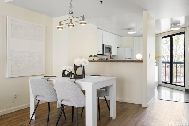601 Van Ness Ave Unit 39, San Francisco, CA 94102 - dining area featuring baseboards, wood finished floors, and a notable chandelier