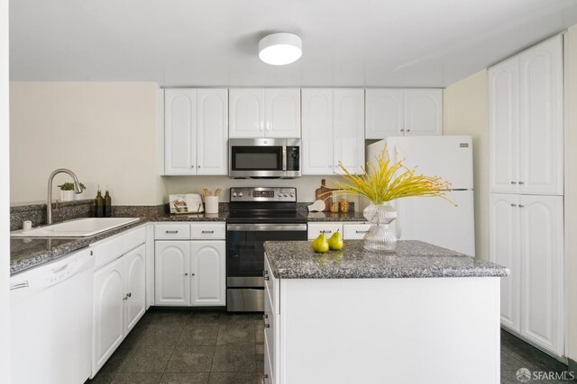 601 Van Ness Ave Unit 39, San Francisco, CA 94102 - kitchen featuring a kitchen island, stainless steel appliances, white cabinets, and a sink
