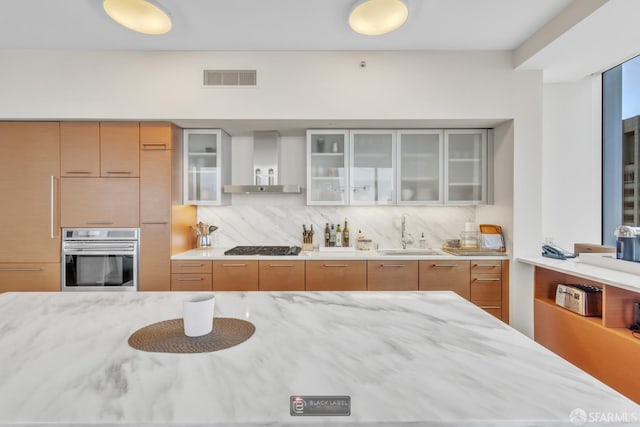 301 Mission St Unit 40D, San Francisco, CA 94105 - kitchen with stainless steel appliances, a sink, extractor fan, decorative backsplash, and light stone counters