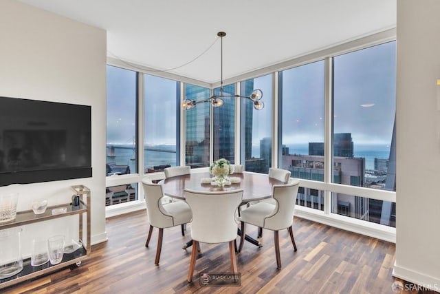 301 Mission St Unit 40D, San Francisco, CA 94105 - dining space with wood finished floors, floor to ceiling windows, a city view, a water view, and baseboards