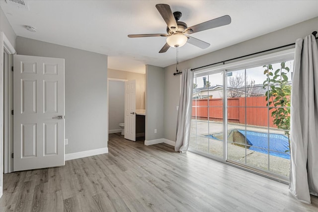 interior space featuring access to exterior, ceiling fan, baseboards, and wood finished floors